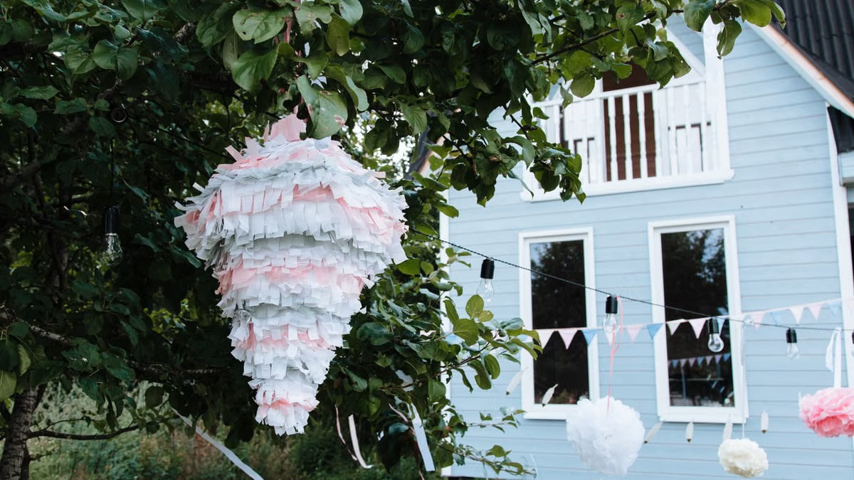 A festive piñata and decorations in a vibrant garden setting, perfect for outdoor celebrations.